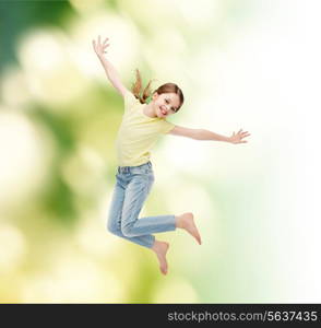 happiness, activity and child concept - smiling little girl jumping