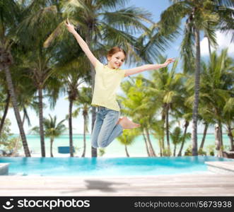 happiness, activity and child concept - smiling little girl jumping