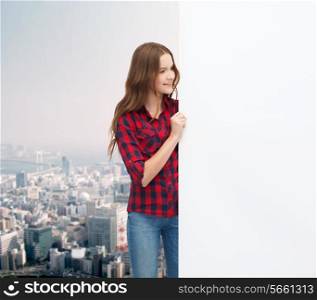 happiness, advertising and people concept - smiling teenage girl with white blank board