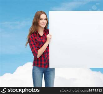 happiness, advertising and people concept - smiling teenage girl with white blank board
