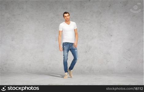 happiness, advertising and people concept - smiling young man in white t-shirt