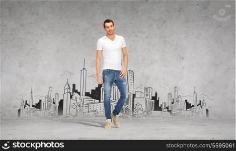 happiness, advertising and people concept - smiling young man in white t-shirt with city drawing on the back