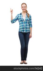 happiness, advertising and people concept - smiling young woman pointing finger up