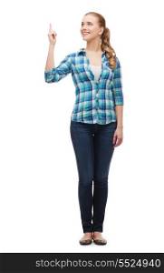 happiness, advertising and people concept - smiling young woman pointing finger up
