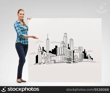 happiness, advertising and people concept - smiling young woman pointing hand to white board with city drawing