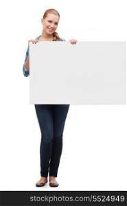 happiness, advertising and people concept - smiling young woman with white blank board