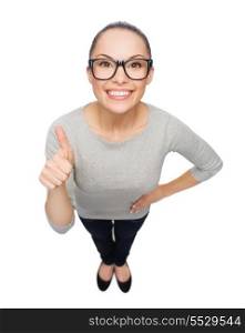 happiness and gesture concept - smiling asian woman in eyeglasses showing thumbs up