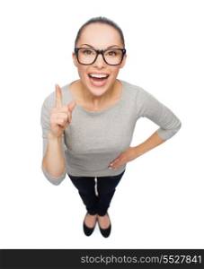 happiness and gesture concept - smiling asian woman in eyeglasses with finger up