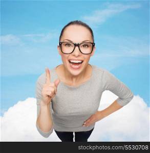 happiness and gesture concept - smiling asian woman in eyeglasses with finger up