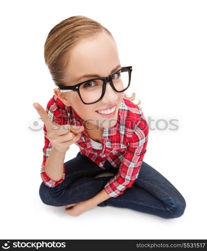 happiness and gesture concept - smiling teenager in eyeglasses with finger up