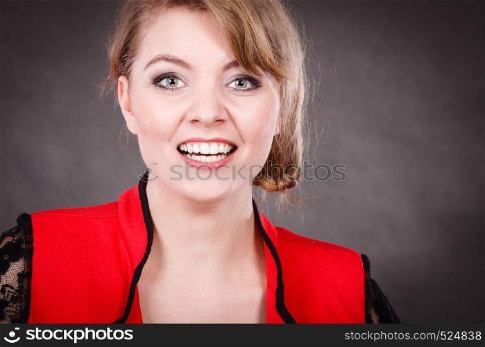 Happiness and joy. Smiling positive young woman in red. Blonde charming elegant lady on dark background.. Happy joyful elegant woman in red.