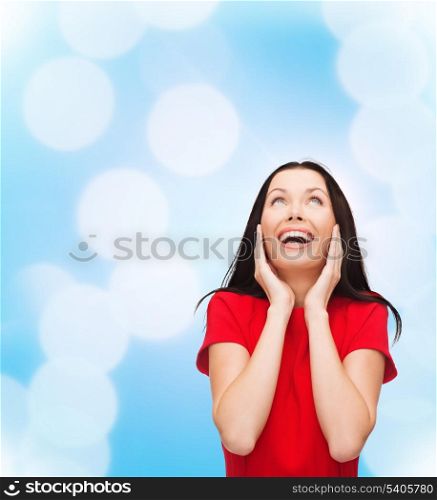 happiness and people concept - amazed laughing young woman in red dress