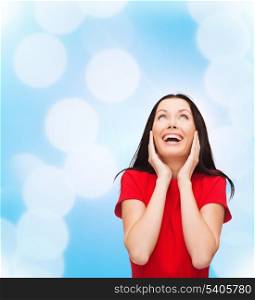 happiness and people concept - amazed laughing young woman in red dress