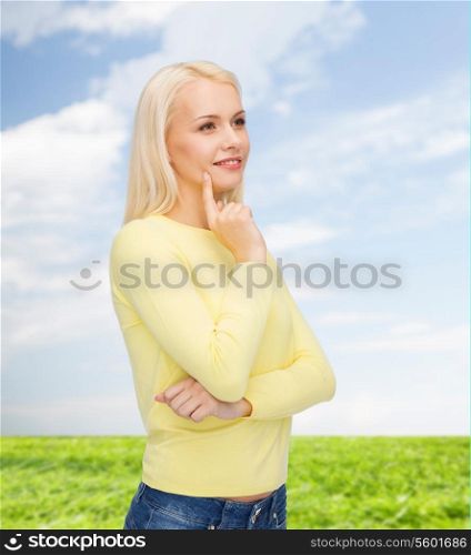 happiness and people concept - happy smiling young woman dreaming