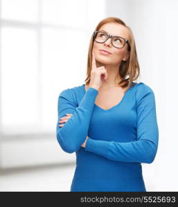 happiness and people concept - happy smiling young woman in black eyeglasses dreaming