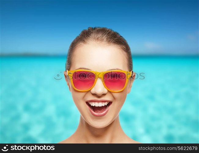 happiness and people concept - portrait of happy teenage girl in pink sunglasses