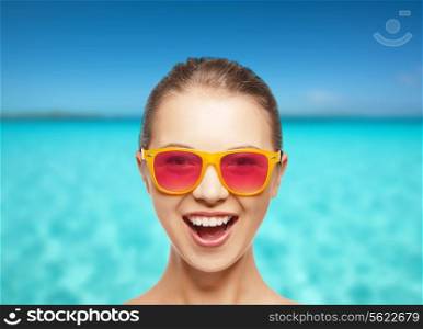 happiness and people concept - portrait of happy teenage girl in pink sunglasses