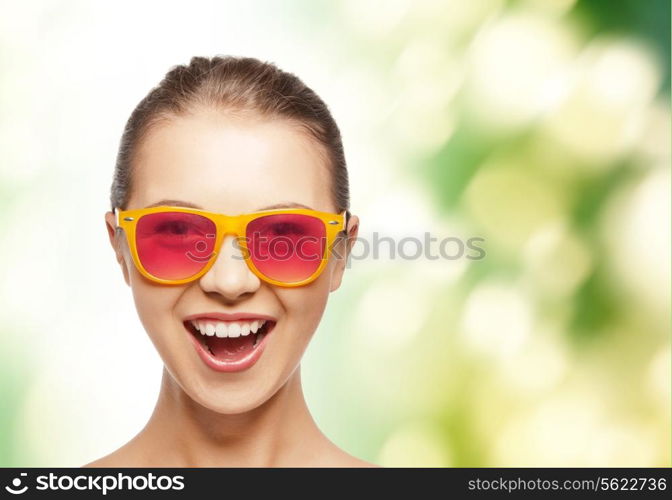 happiness and people concept - portrait of happy teenage girl in pink sunglasses