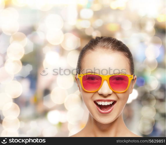 happiness and people concept - portrait of happy teenage girl in pink sunglasses