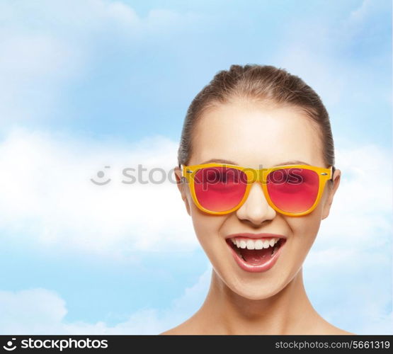 happiness and people concept - portrait of happy teenage girl in pink sunglasses