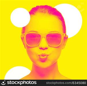 happiness and people concept - portrait of teenage girl in pink sunglasses blowing kiss, trendy duotone effect. girl in pink sunglasses blowing kiss