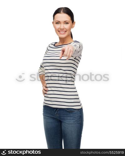 happiness and people concept - smiling girl in casual clothes pointing at you
