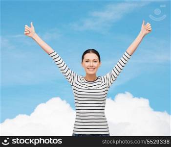 happiness and people concept - smiling girl in casual clothes showing thumbs up