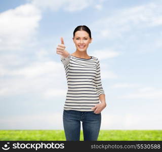 happiness and people concept - smiling girl in casual clothes showing thumbs up