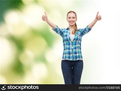 happiness and people concept - smiling girl in casual clothes showing thumbs up over green background