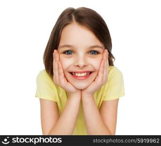 happiness and people concept - smiling little girl holding head over white background. smiling little girl over white background