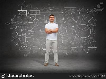 happiness and people concept - smiling man in white t-shirt with crossed arms over big scheme and concrete background