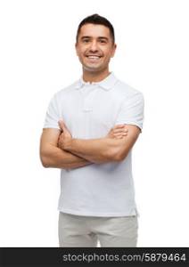 happiness and people concept - smiling man in white t-shirt with crossed arms