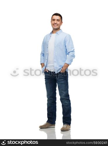 happiness and people concept - smiling man wearing shirt and jeans with hands in pockets. smiling man with hands in pockets