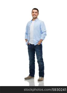 happiness and people concept - smiling man wearing shirt and jeans with hands in pockets. smiling man with hands in pockets