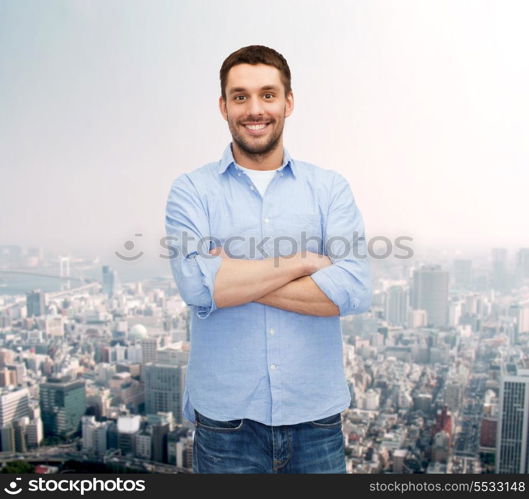 happiness and people concept - smiling man with crossed arms