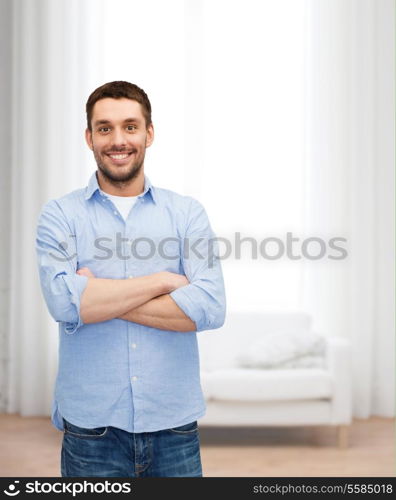 happiness and people concept - smiling man with crossed arms