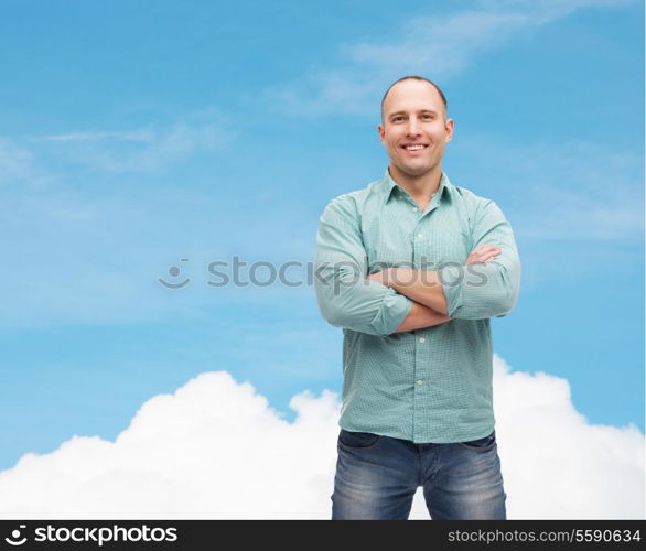 happiness and people concept - smiling man with crossed arms