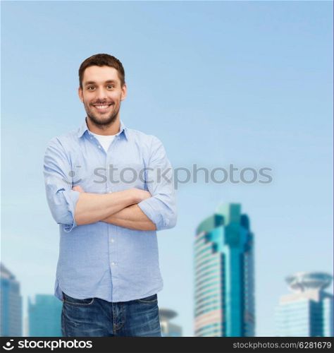 happiness and people concept - smiling man with crossed arms
