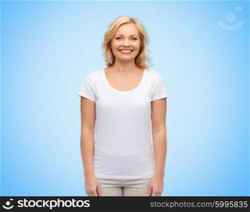 happiness and people concept - smiling middle aged woman in blank white t-shirt over blue background. smiling middle aged woman in blank white t-shirt