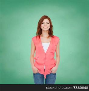 happiness and people concept - smiling teenage girl in casual clothes over green board background