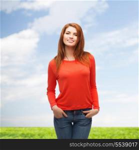happiness and people concept - smiling teenager in casual top and jeans outdoors