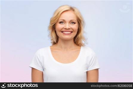 happiness and people concept - smiling woman in blank white t-shirt over rose quartz and serenity gradient background. smiling woman in blank white t-shirt