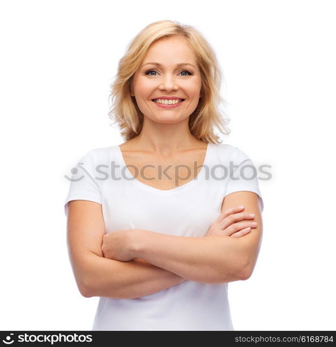 happiness and people concept - smiling woman in blank white t-shirt with crossed arms. smiling woman in blank white t-shirt