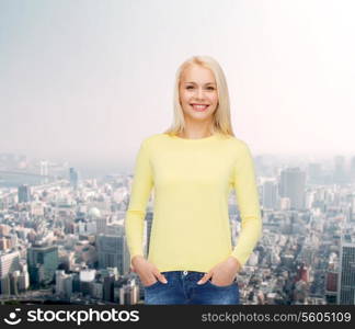 happiness and people concept - smiling young woman in casual clothes