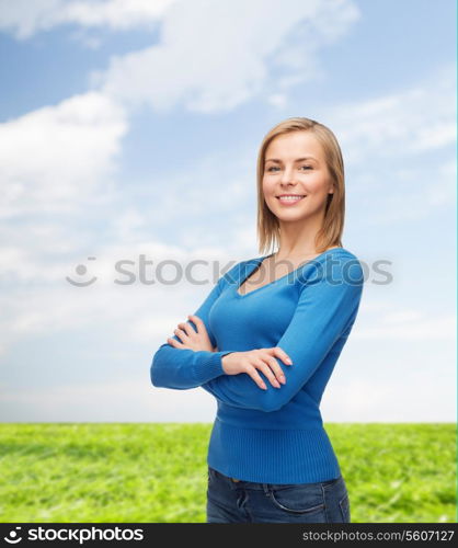 happiness and people concept - smiling young woman in casual clothes