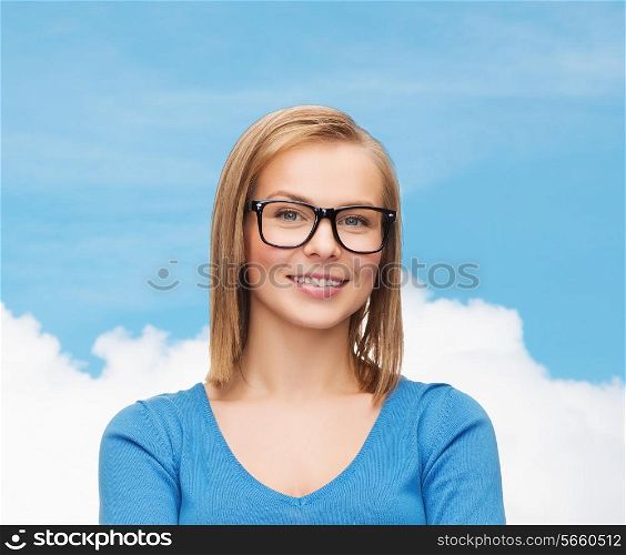 happiness and people concept - smiling young woman in casual clothes and black eyeglasses