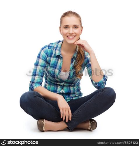 happiness and people concept - smiling young woman in casual clothes sitiing on floor