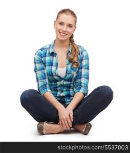 happiness and people concept - smiling young woman in casual clothes sitiing on floor