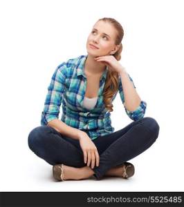 happiness and people concept - smiling young woman in casual clothes sitiing on floor and dreaming