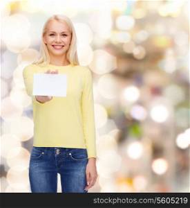 happiness and people concept - smiling young woman in casual clothes with white blank business or name card
